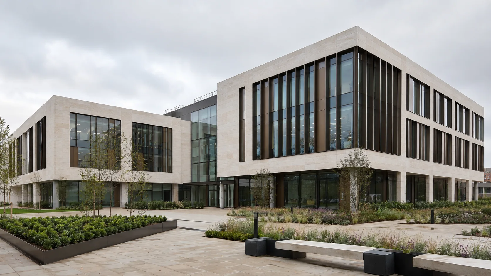 Illustrative limestone office building with bronze fins and a landscaped courtyard